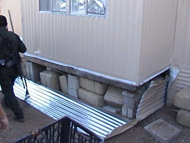 Marijuana bundles concealed beneath a trailer. Loads like this were built to move unnoticed—hidden in plain sight and designed to withstand scrutiny.