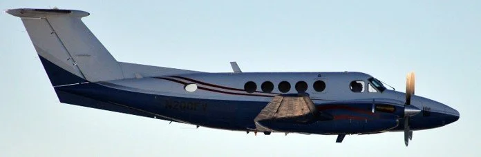 Actual surveillance photo of a Beechcraft King Air carrying cocaine north from the Venezuela/Colombia border. Aircraft like this moved product into the system long before it reached the US/Mexico border. Blacked-out windows concealed the illicit carg