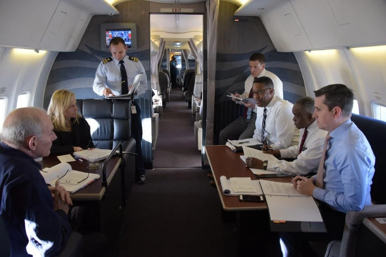  Aboard an Air Force aircraft during a high-level DHS operational briefing. My role as a law enforcement advisor placed me inside senior leadership discussions shaping national strategy. I am visible in the upper right corner.

