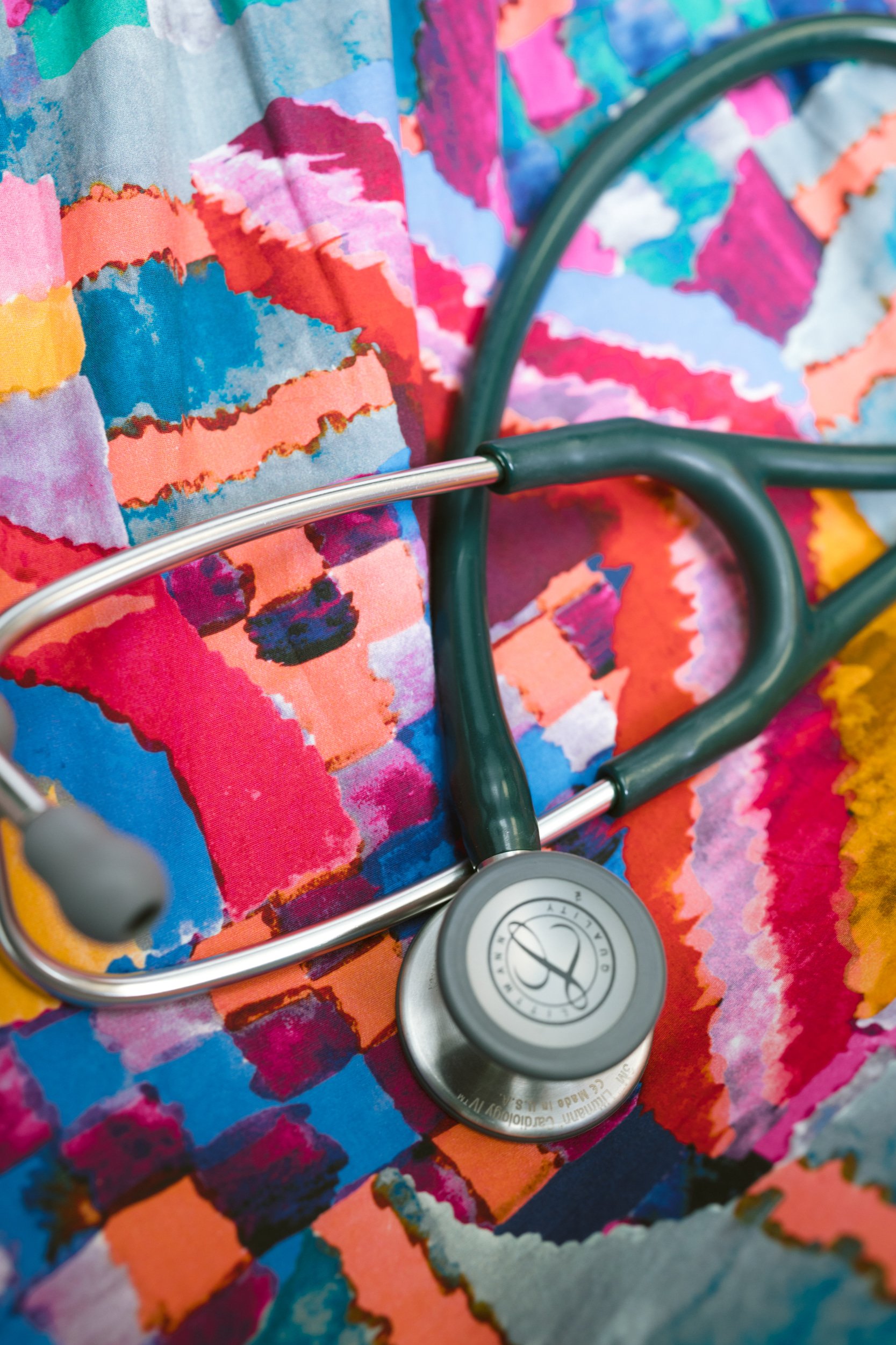 Stethescope laying against colorful fabric