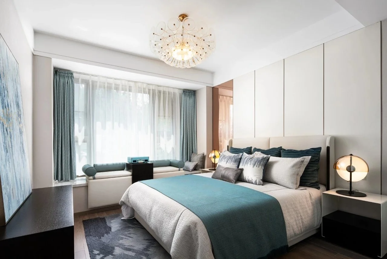 Modern bedroom with teal and grey bedding complimented by sheer curtains and teal block out curtains enhancing privacy