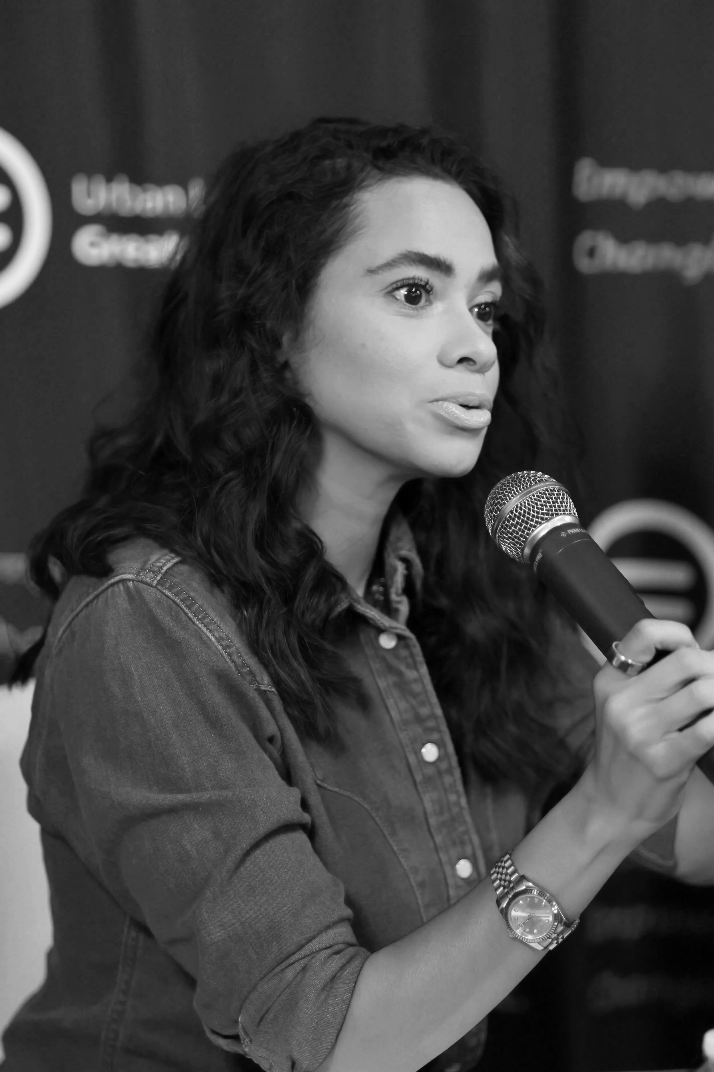 Woman holding microphone speaking at a ULGC event