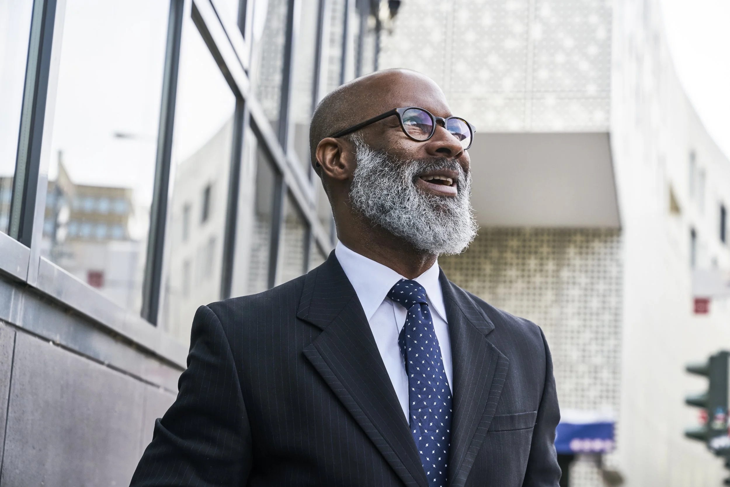 portrait of a mature businessman in a suit looking off into the horizon