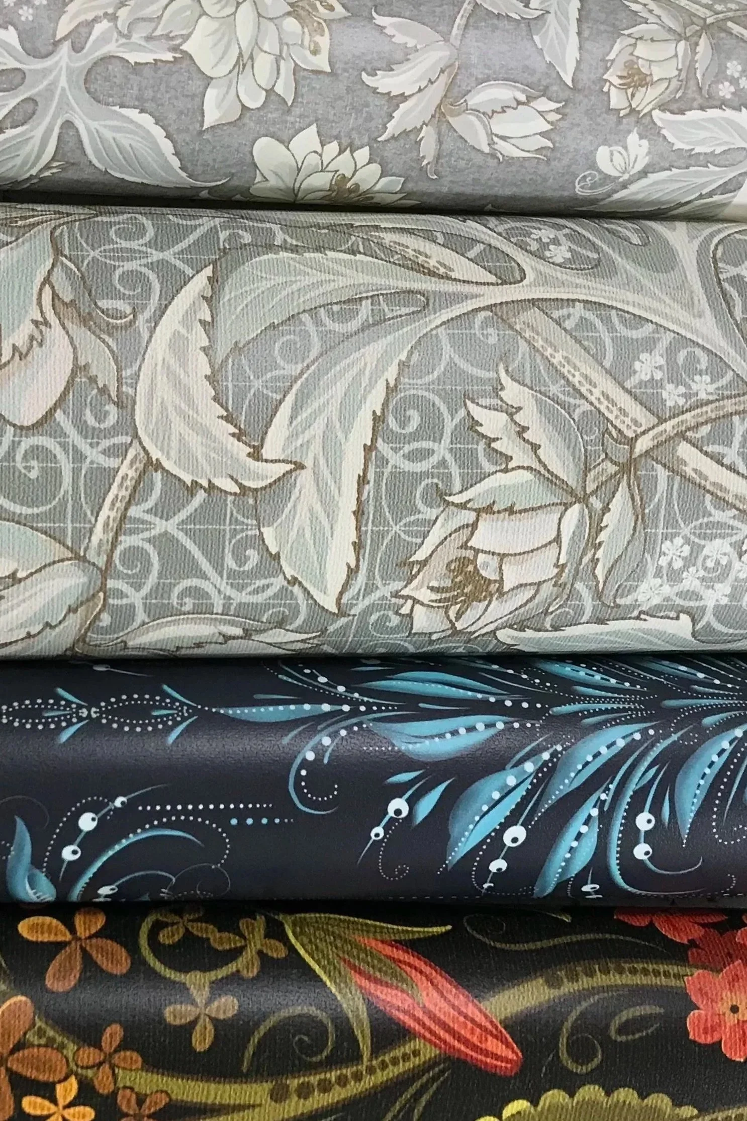 Rolls of heritage-inspired botanical wallpaper and fabric patterns by Wild Geranium Design.