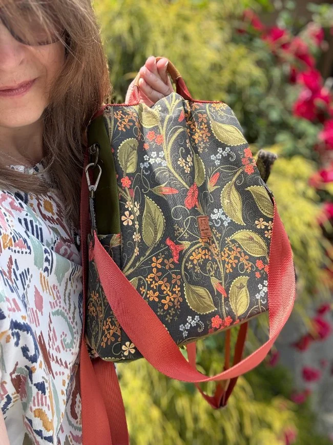 Alla Solo shows a heritage-inspired botanical surface pattern by Wild Geranium Design shown on a handmade fabric bag in a garden setting.