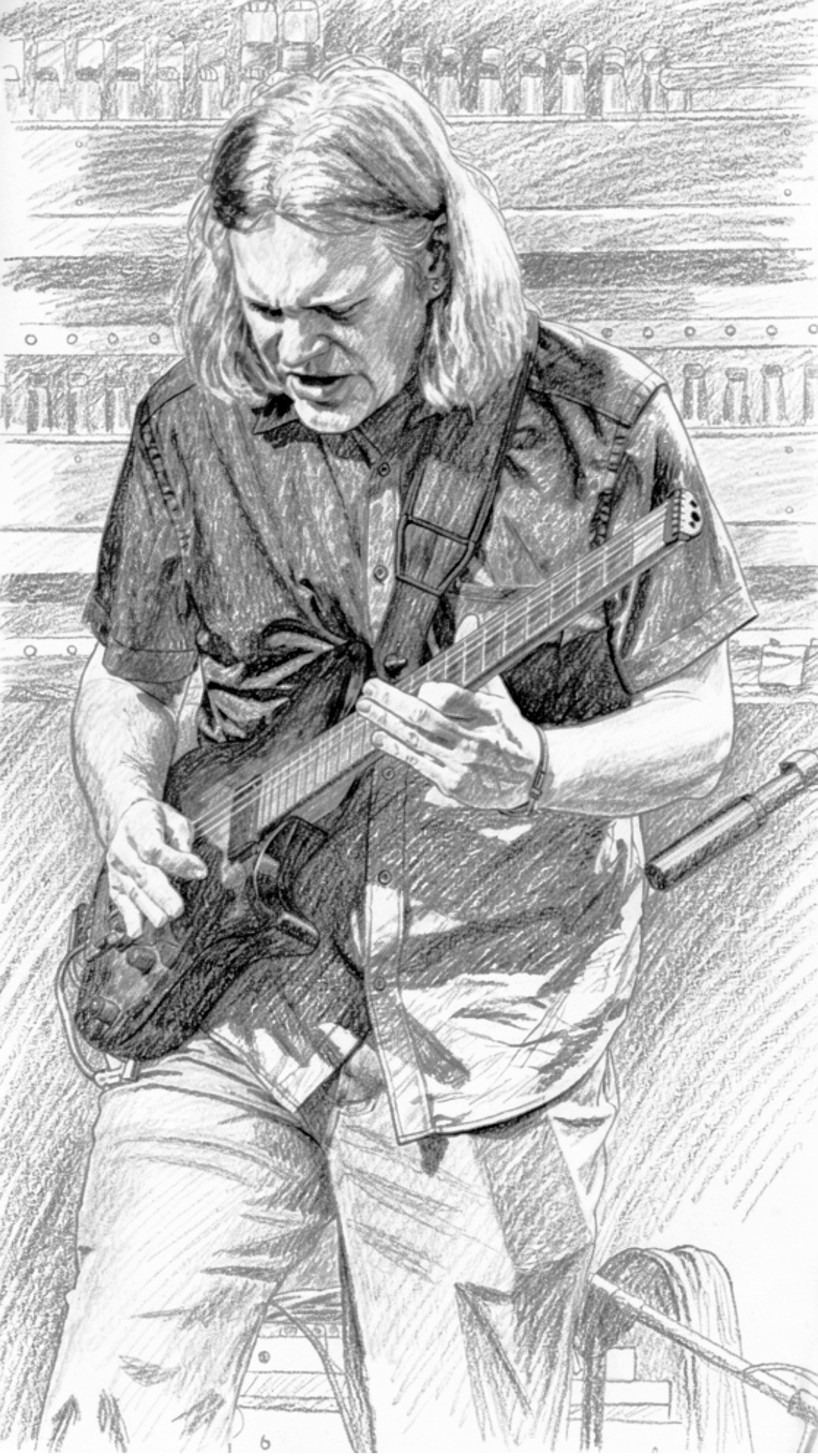 A man with long hair playing an electric guitar outdoors, with a background of trees and a park bench.