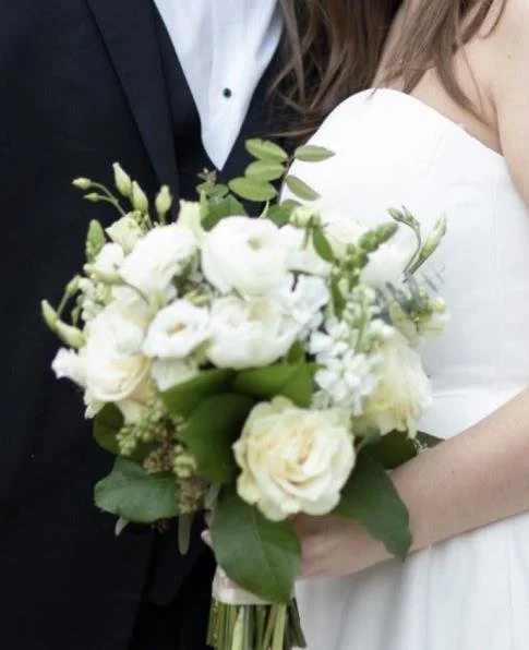 Couple holding a white, green and soft blue Simply Florals wedding bouquet in Atlanta
