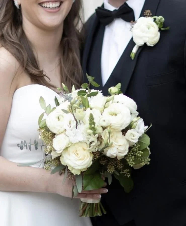 Bride and groom with white bouquet and boutonniere delivered by Simply Florals