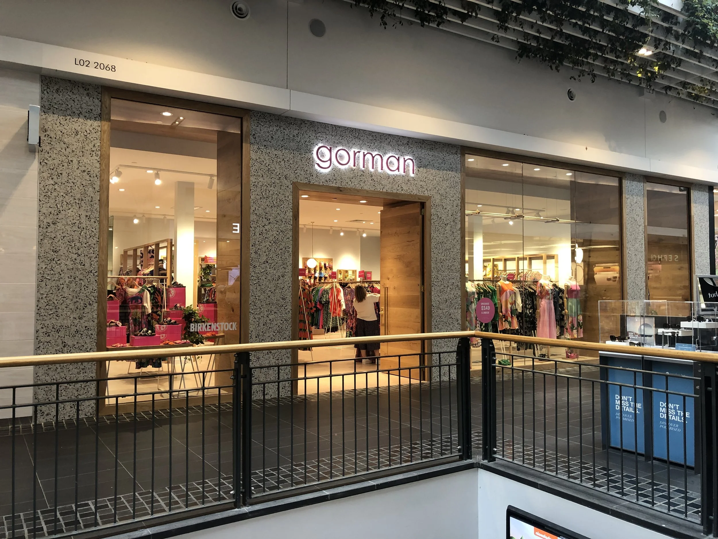 Front view of the Gorman retail store inside a shopping mall, with bright interior and clothing displays visible through large glass windows.
