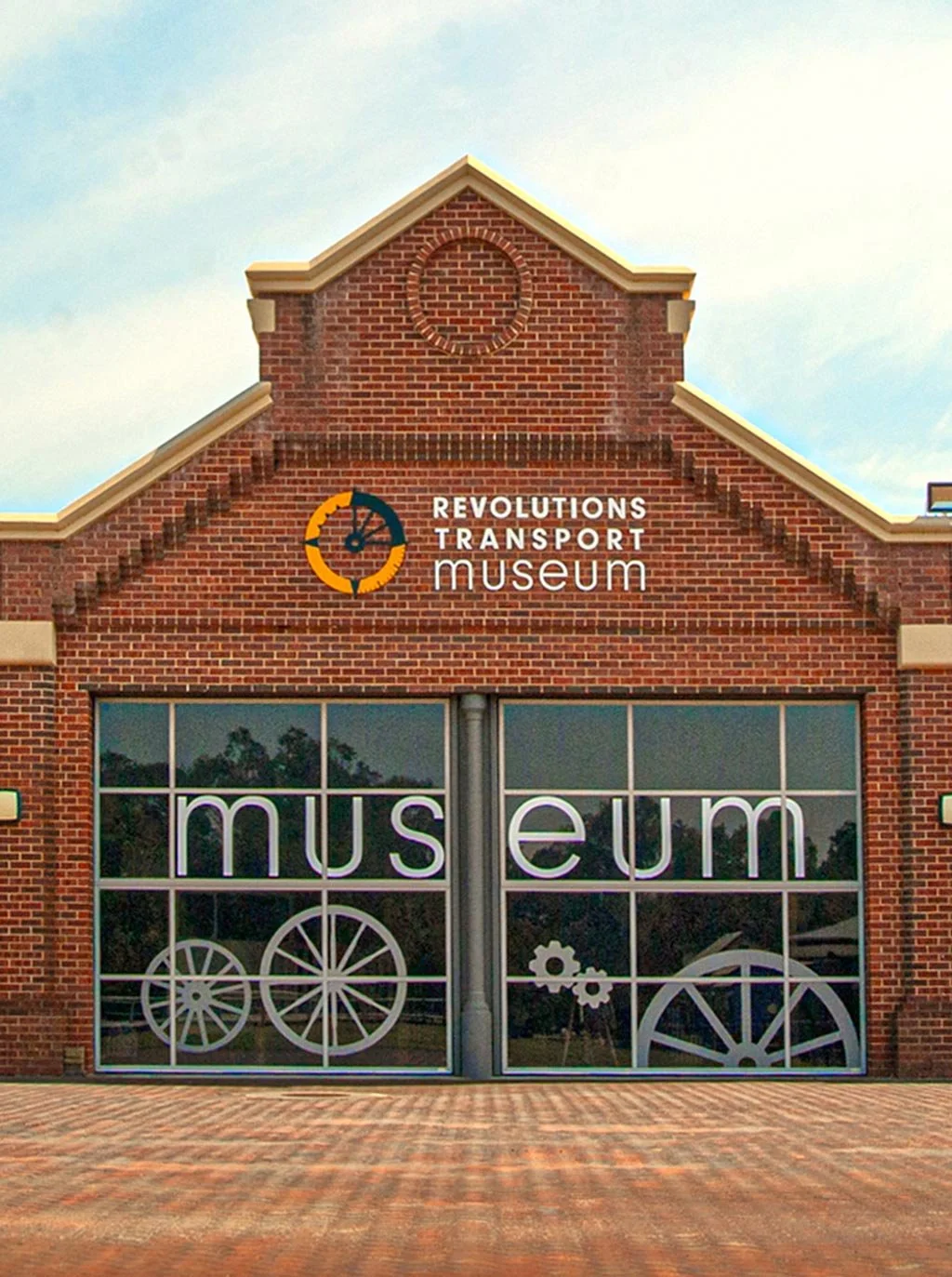The front facade of the Revolutions Transport Museum, showcasing the large window graphics designed by Dessein