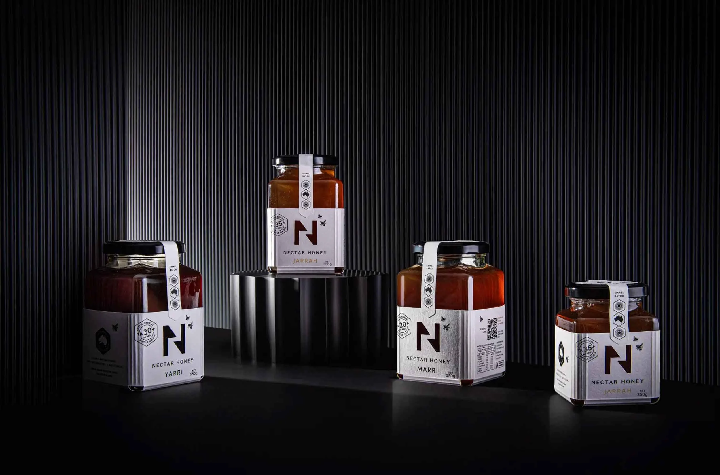 A stylised photograph of the label design of Nectar Honey, showcasing the labels attached to the jars