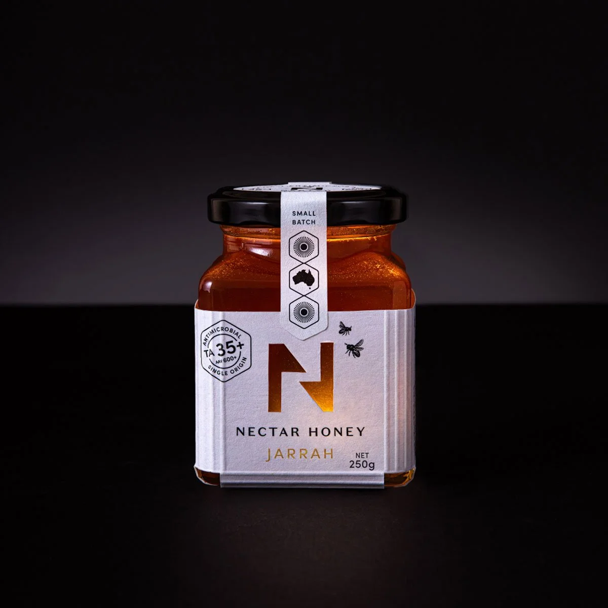 A stylised photograph of the front of the label design of Nectar Honey's Jarrah honey 250g size
