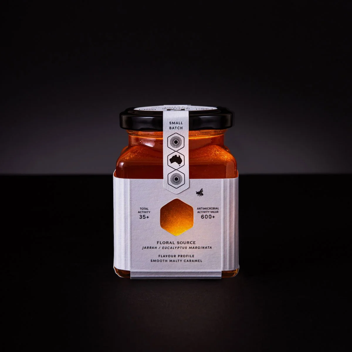 A stylised photograph of the back of the label design of Nectar Honey's Jarrah honey 250g size
