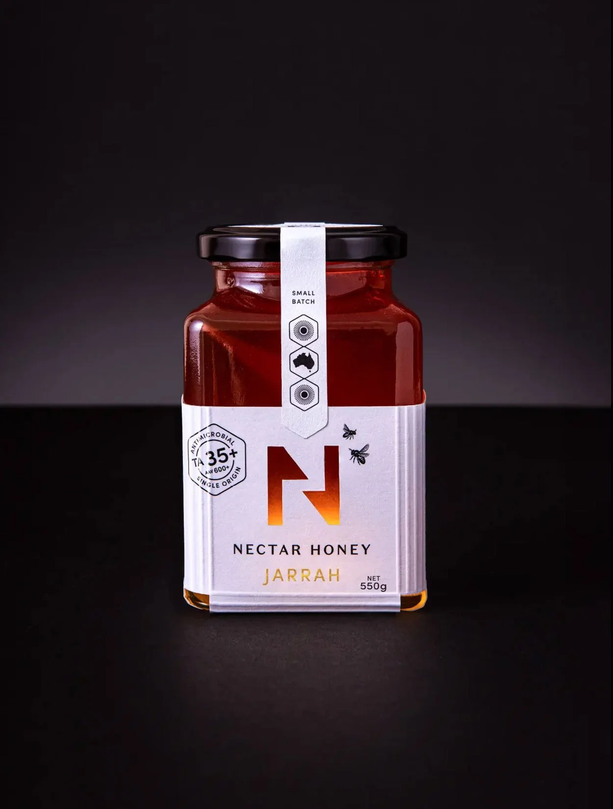A stylised photograph of the front of the label design of Nectar Honey's Jarrah honey 550g size