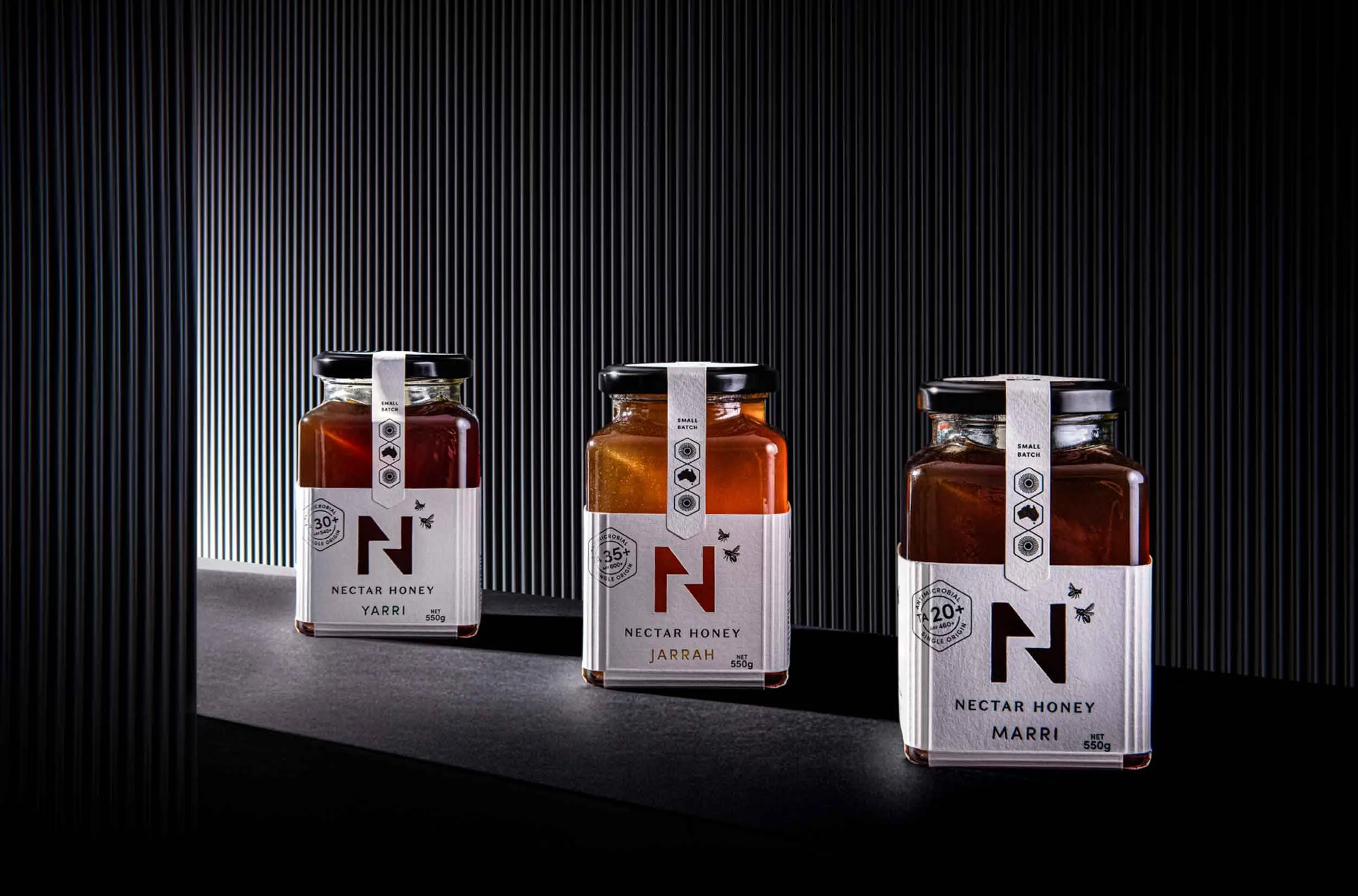 A stylised photograph of the front of the label design of Nectar Honey's Jarrah, Yarri and Marri honey jars