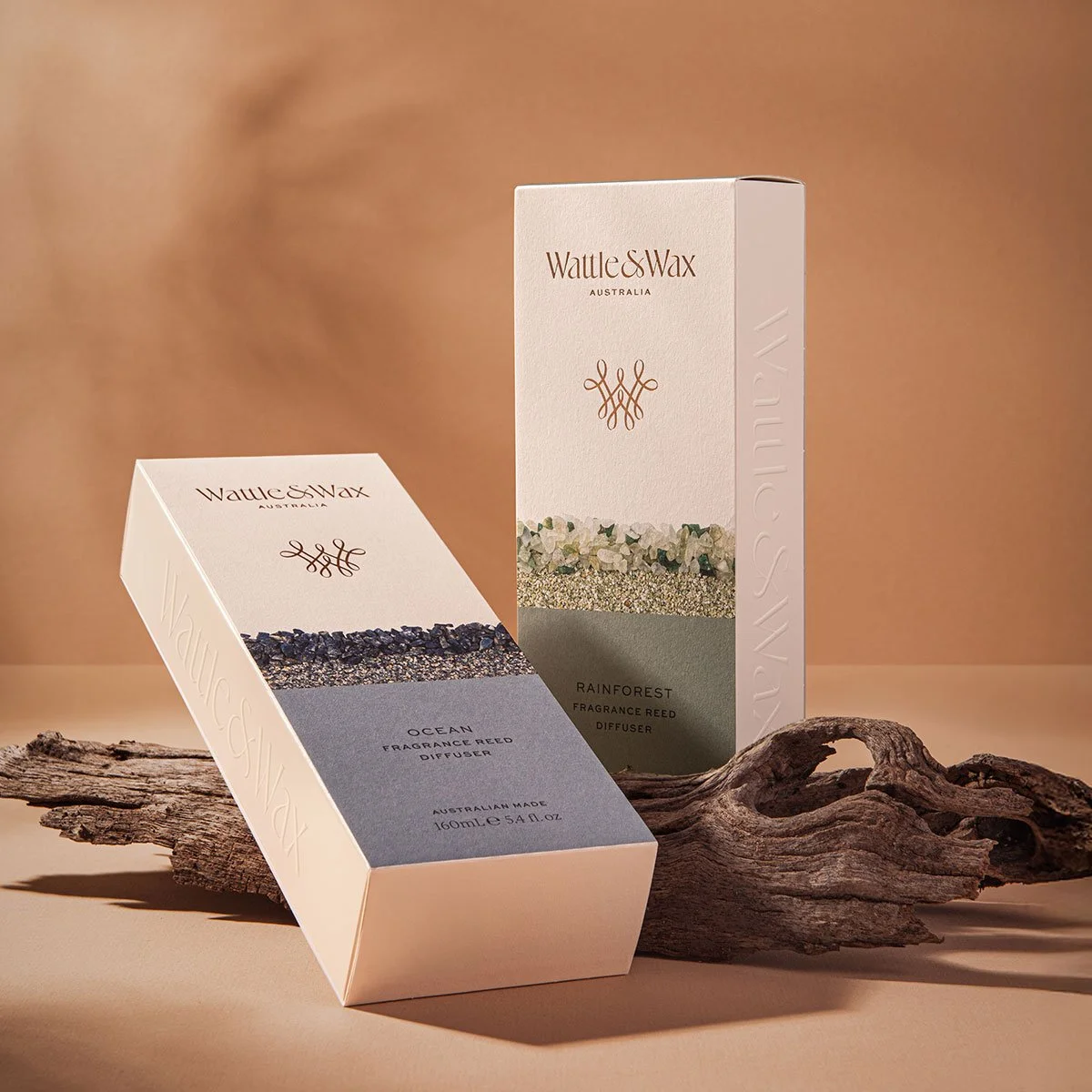 A stylised photograph of two of Wattle and Wax Australia's Ocean and Rainforest reed diffusers