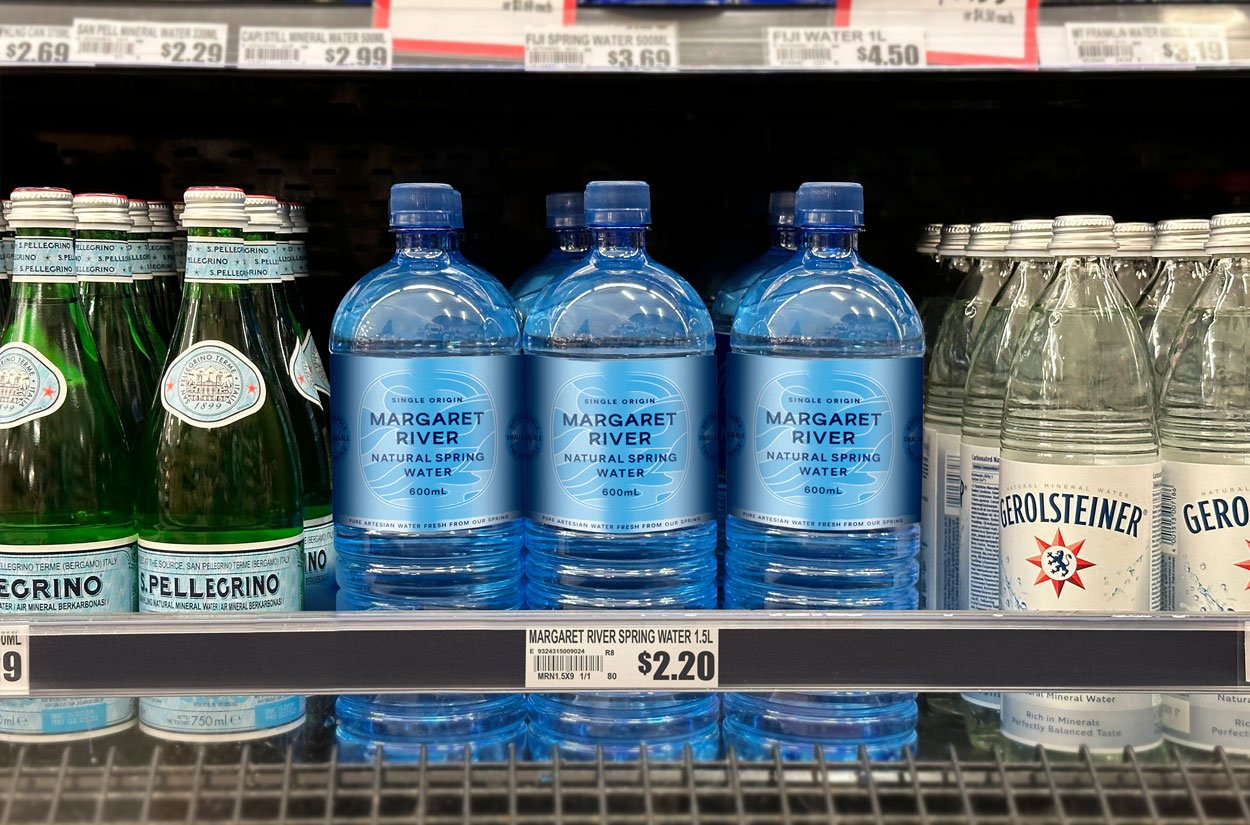 600ml bottles of Margaret River Natural spring Water on the shelf in a supermarket, between competitor brands