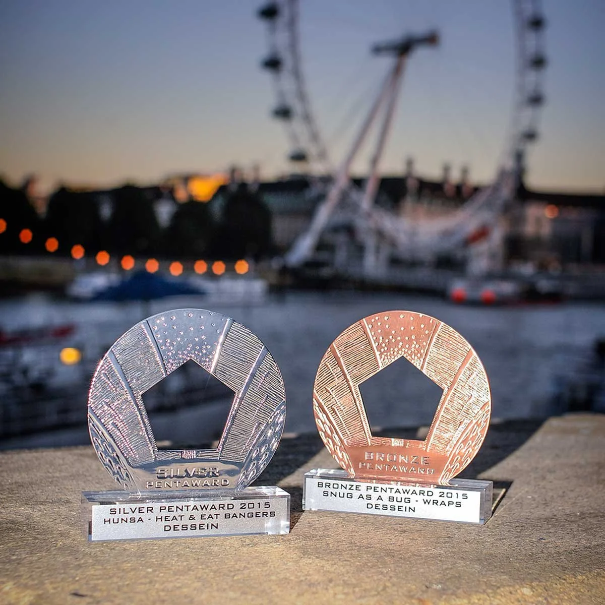 A photograph of two awards presented to Dessein for graphic design