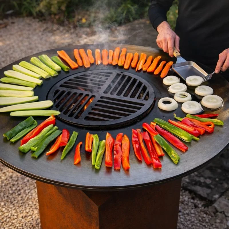 Colorful sliced vegetables, including cucumbers, red bell peppers, green bell peppers, carrots, and onions, are arranged in a circle on a grill.