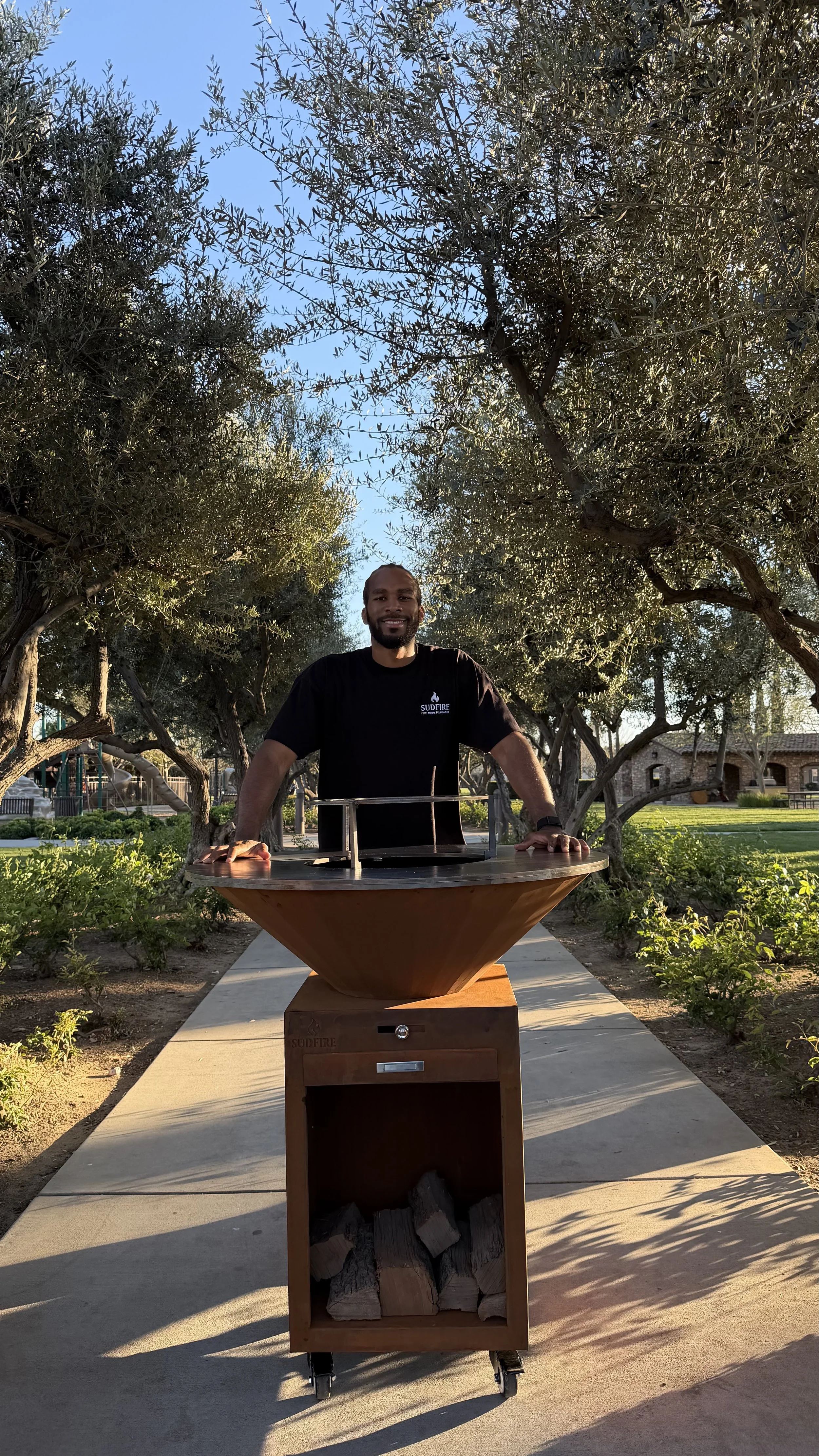 Sudfire founder with Hearth 39 live fire grill, outdoor cooking brand and social gathering concept
