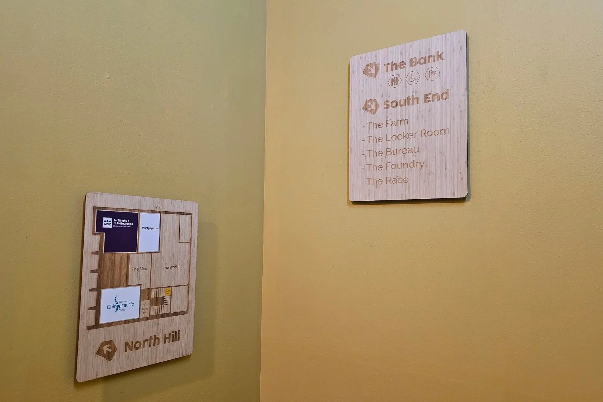 Laser-cut bamboo directional signage and digital print sticker overlays