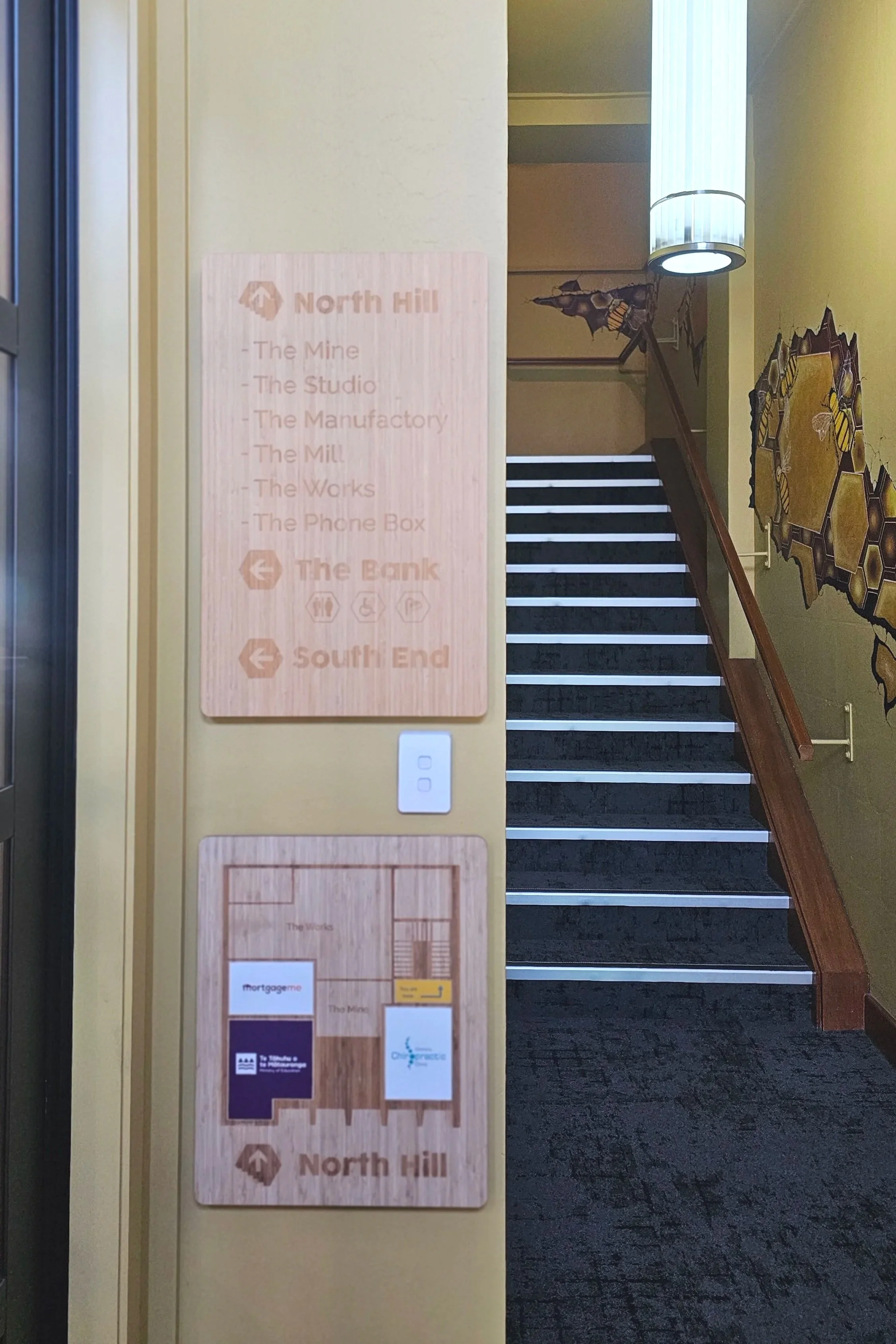 Laser-cut bamboo directional signage and digital print sticker overlays