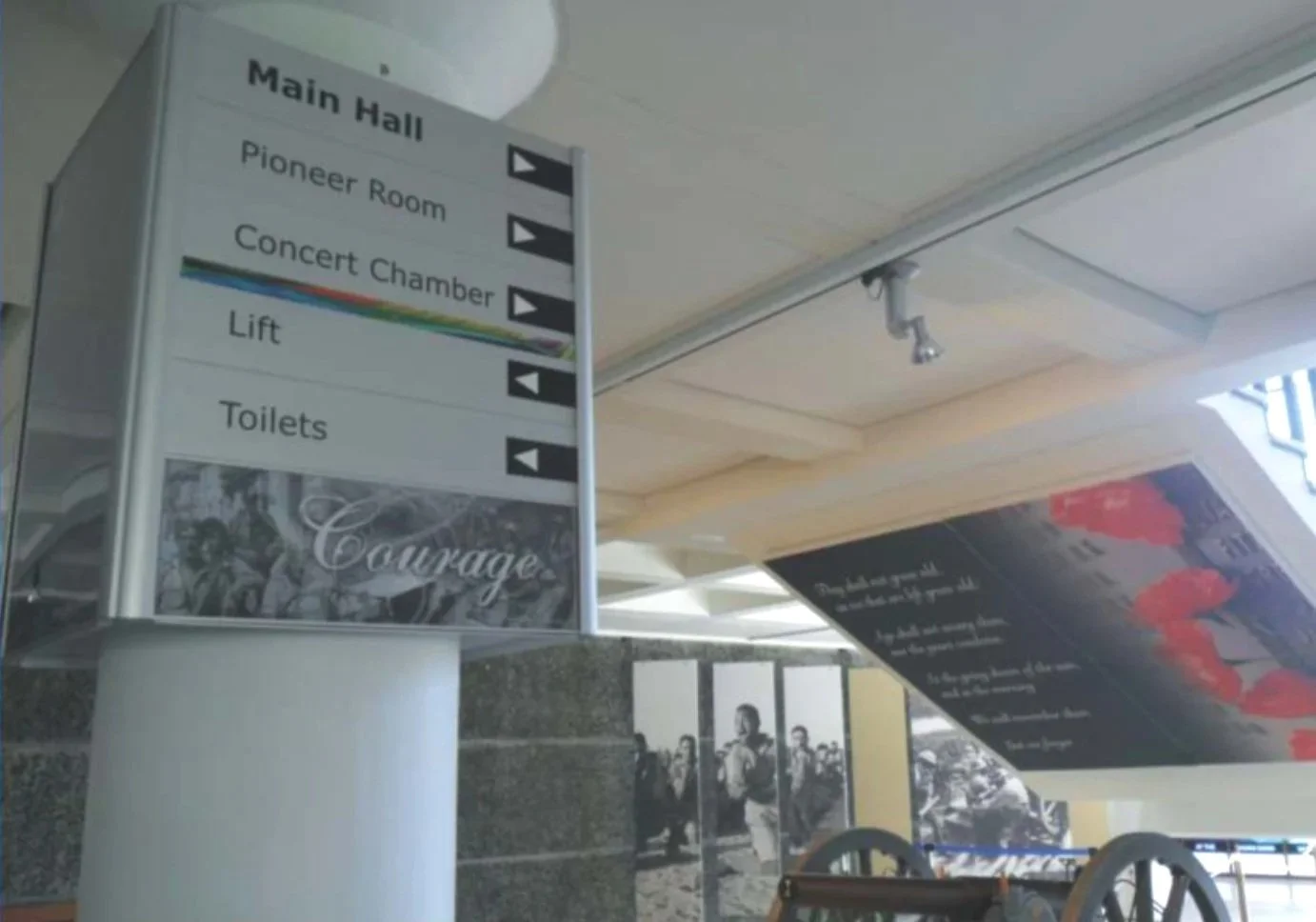 Digitally-printed accoustic absorbing panels mounted to walls, vinyl cut text to directional signage