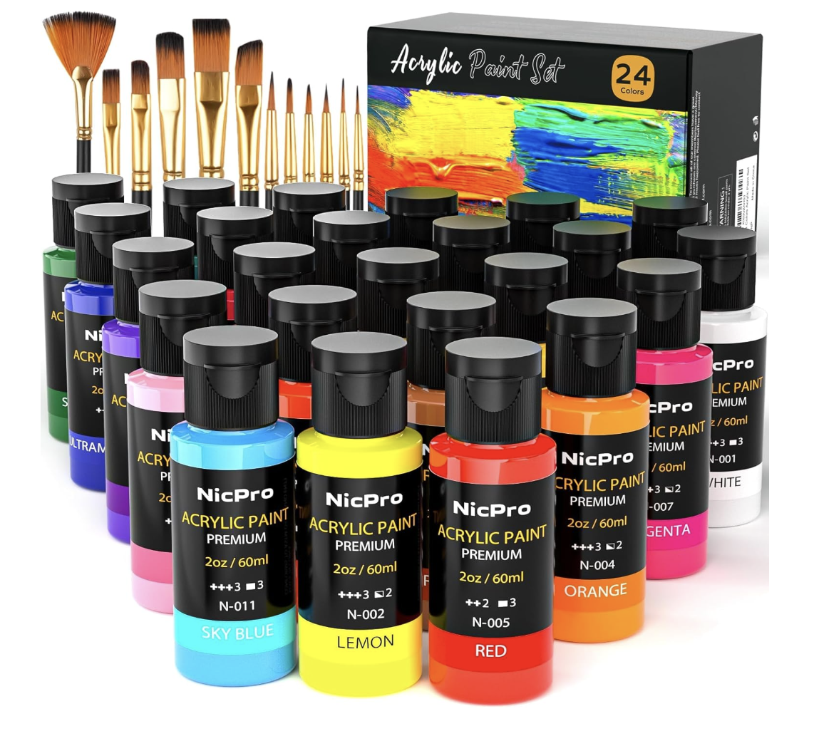 Set of acrylic paint bottles in various colors, paintbrushes, and a box of acrylic paints, suitable for art projects.