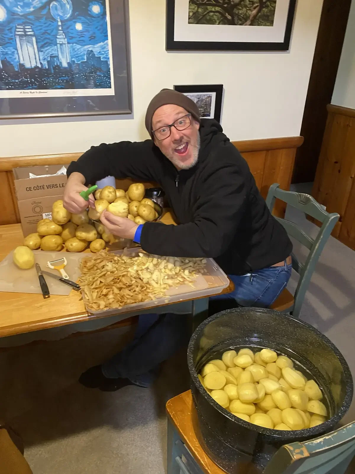 Bill peeling 40 pounds of potatoes.