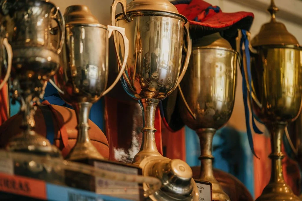 Vintage Football Trophys line the shelves at the Clubhouse