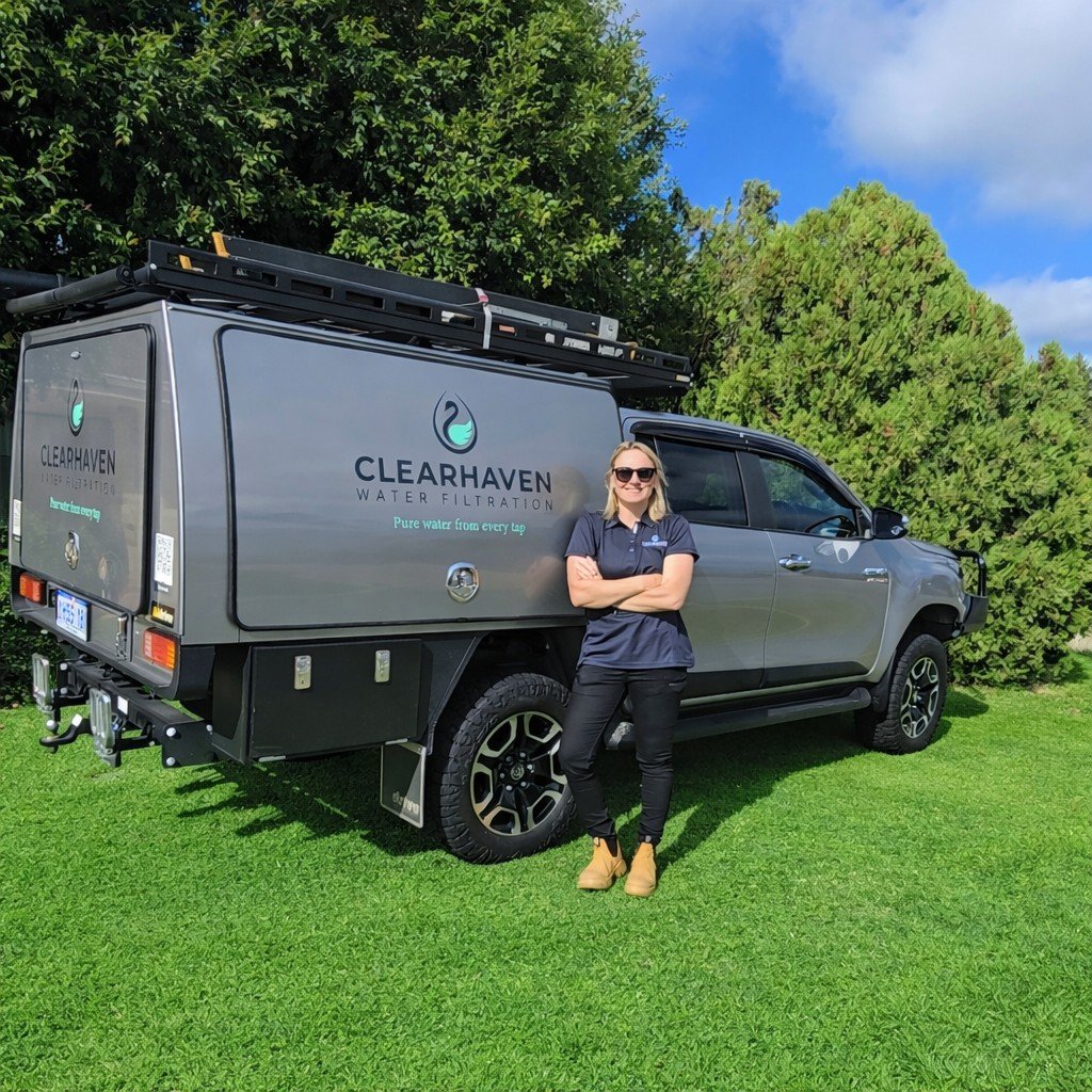 Jade De Joode, founder of ClearHaven Water Filtration, standing beside the ClearHaven service vehicle in Perth, Western Australia.