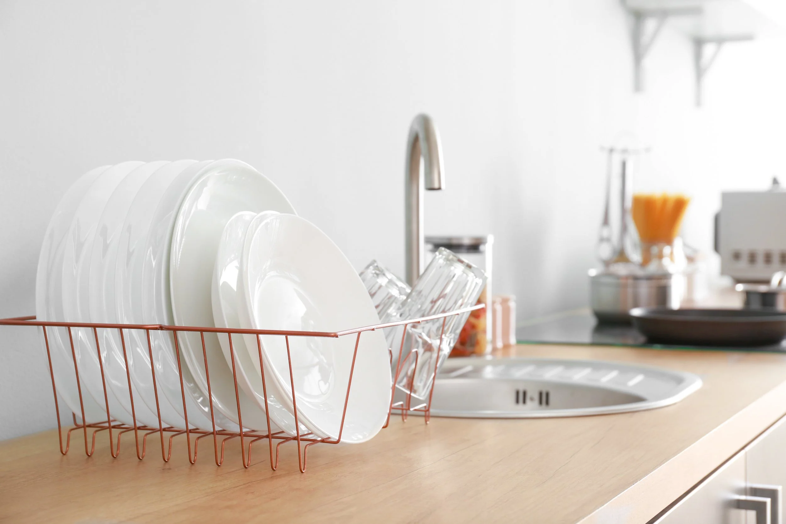 Clean dishes and glassware drying after washing with filtered water from a ClearHaven whole-home water filtration system, helping reduce mineral residue and water spots in Perth homes.