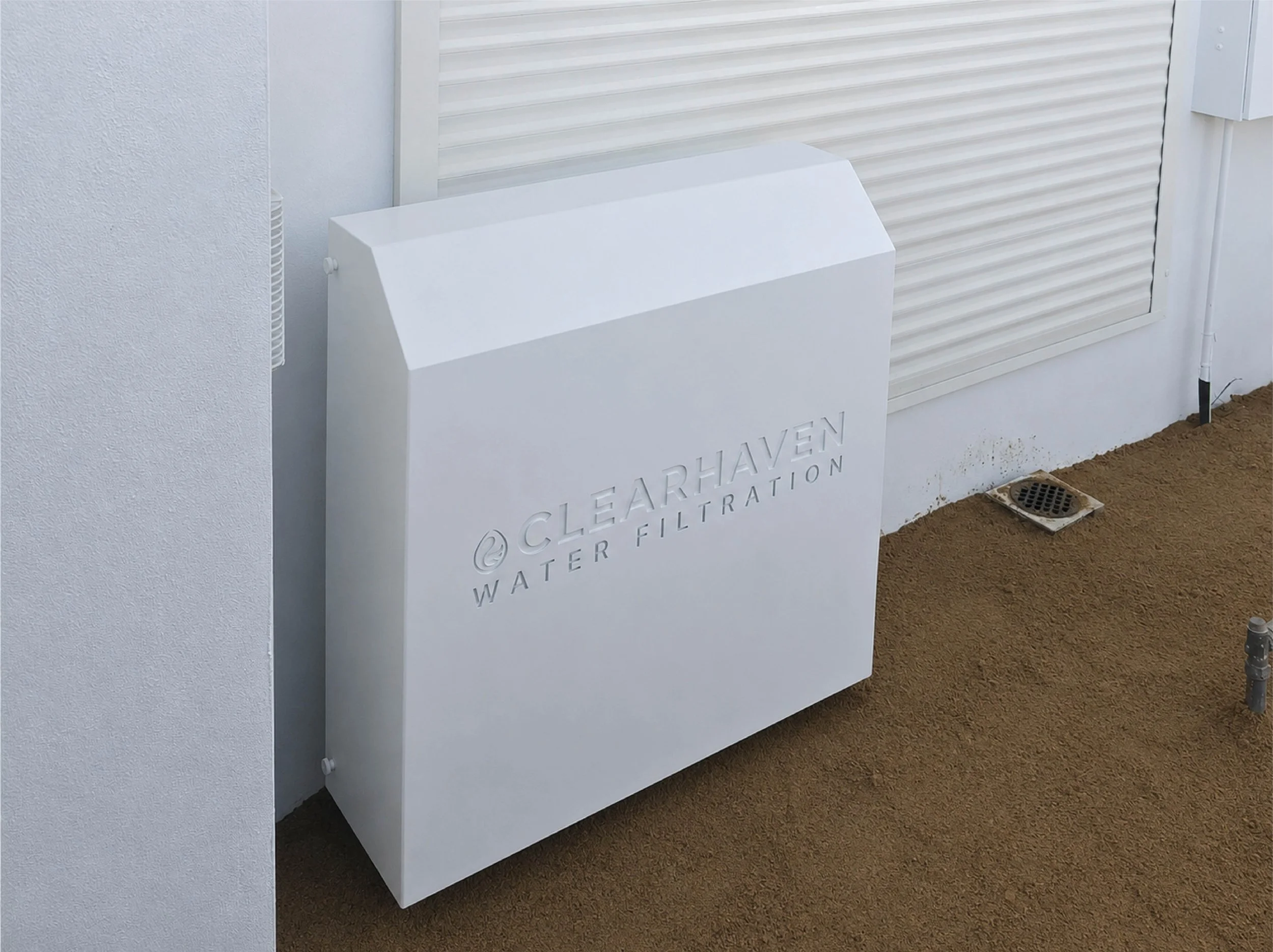 ClearHaven whole-home water filtration system with a custom Dover White Colourbond cover professionally installed in Perth.