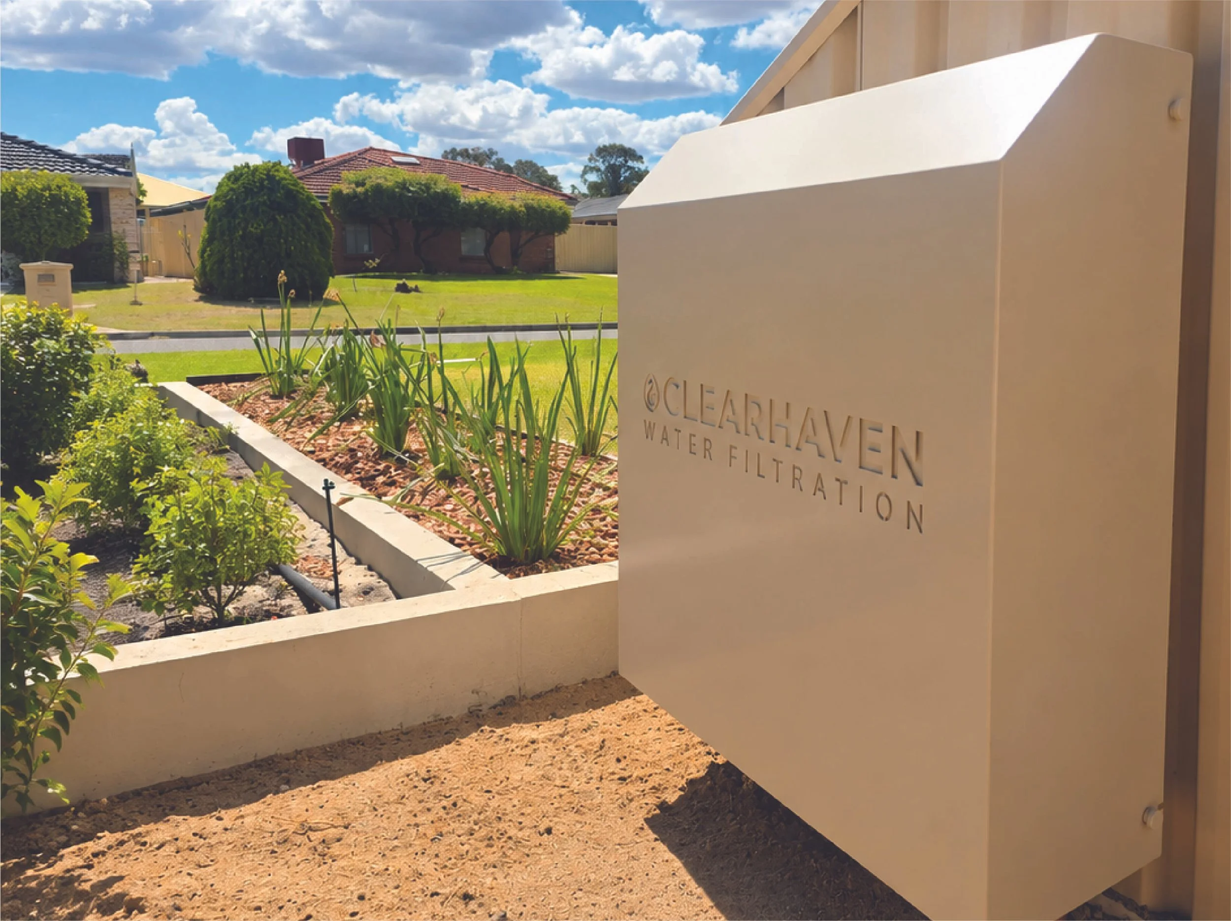 ClearHaven whole-home water filtration system with a Paperbark cover, beautifully integrated with the home and garden in Bateman, WA.
