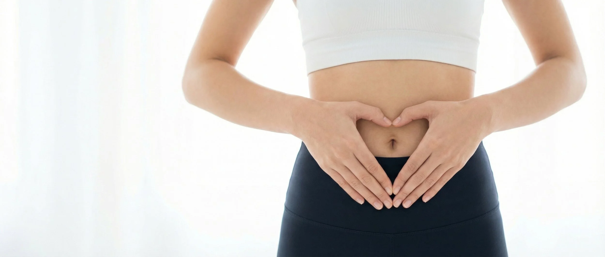 Person holding their stomach, representing the digestive wellness benefits of drinking clean, filtered water from a ClearHaven whole-home water filtration system in a Perth home.