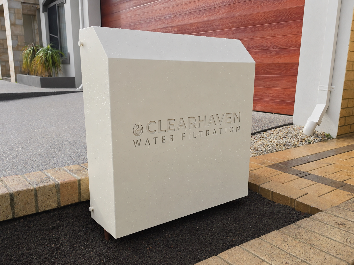 ClearHaven whole-home water filtration system with a custom Classic Cream Colourbond cover designed to complement a Perth home.