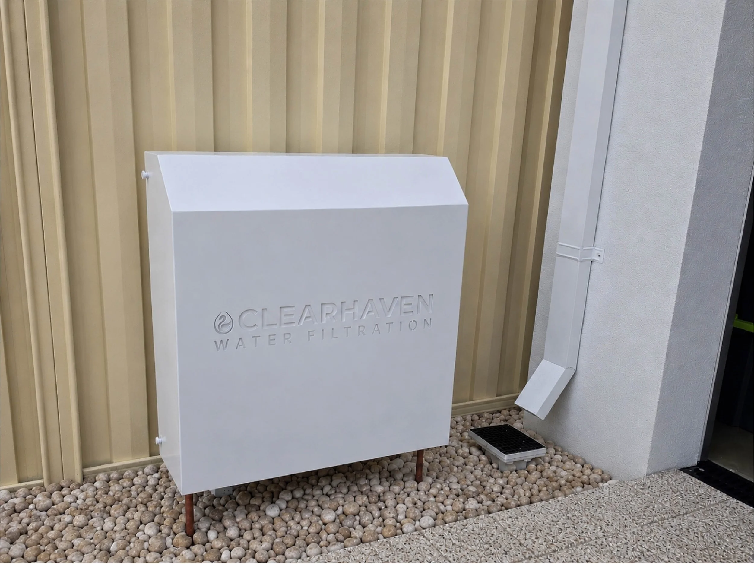 ClearHaven whole-home water filtration system with a custom Dover White Colourbond cover professionally installed in Perth.