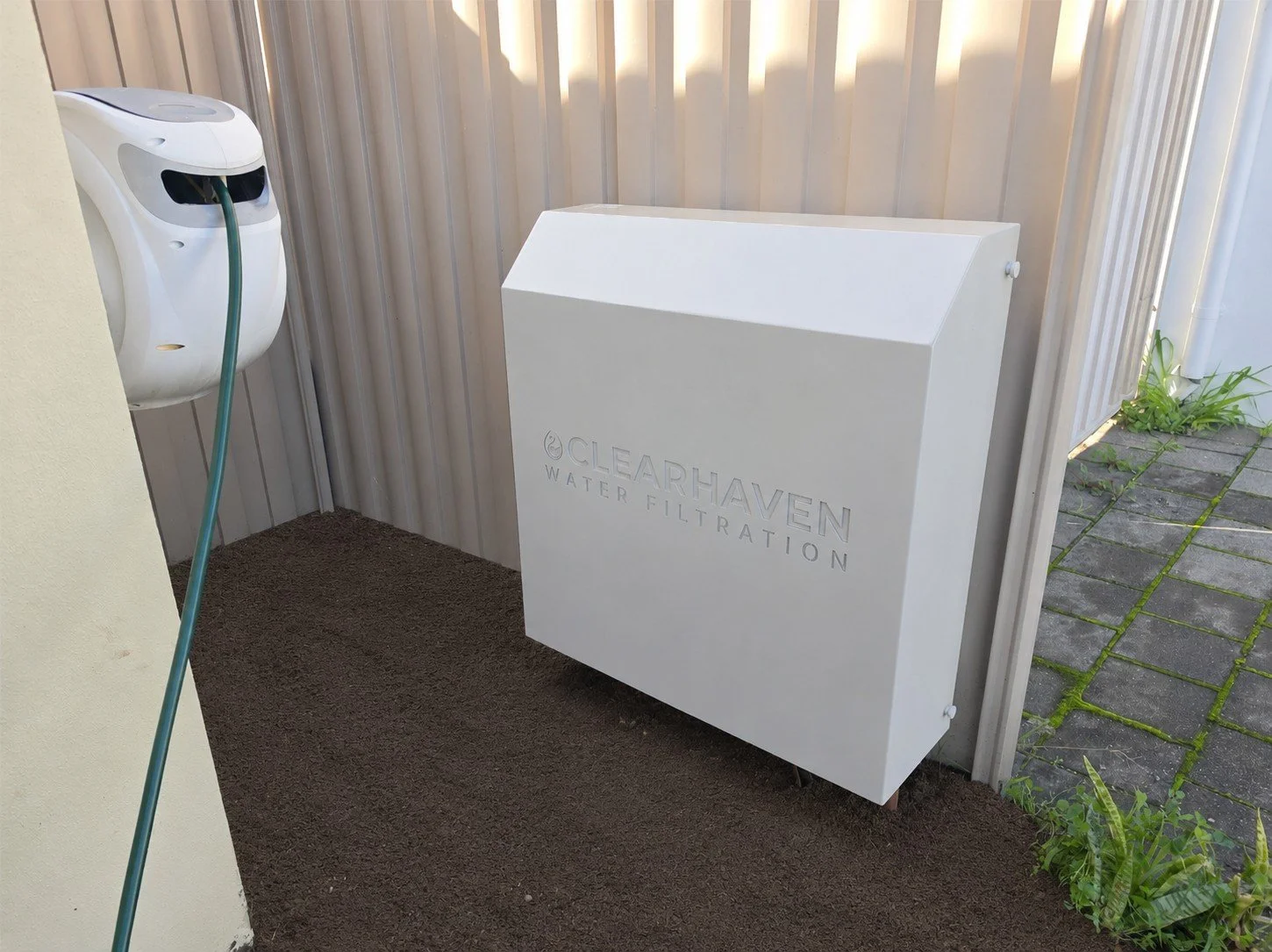 ClearHaven whole-home water filtration system with a custom Dune Colourbond cover designed to blend seamlessly with a Perth home.
