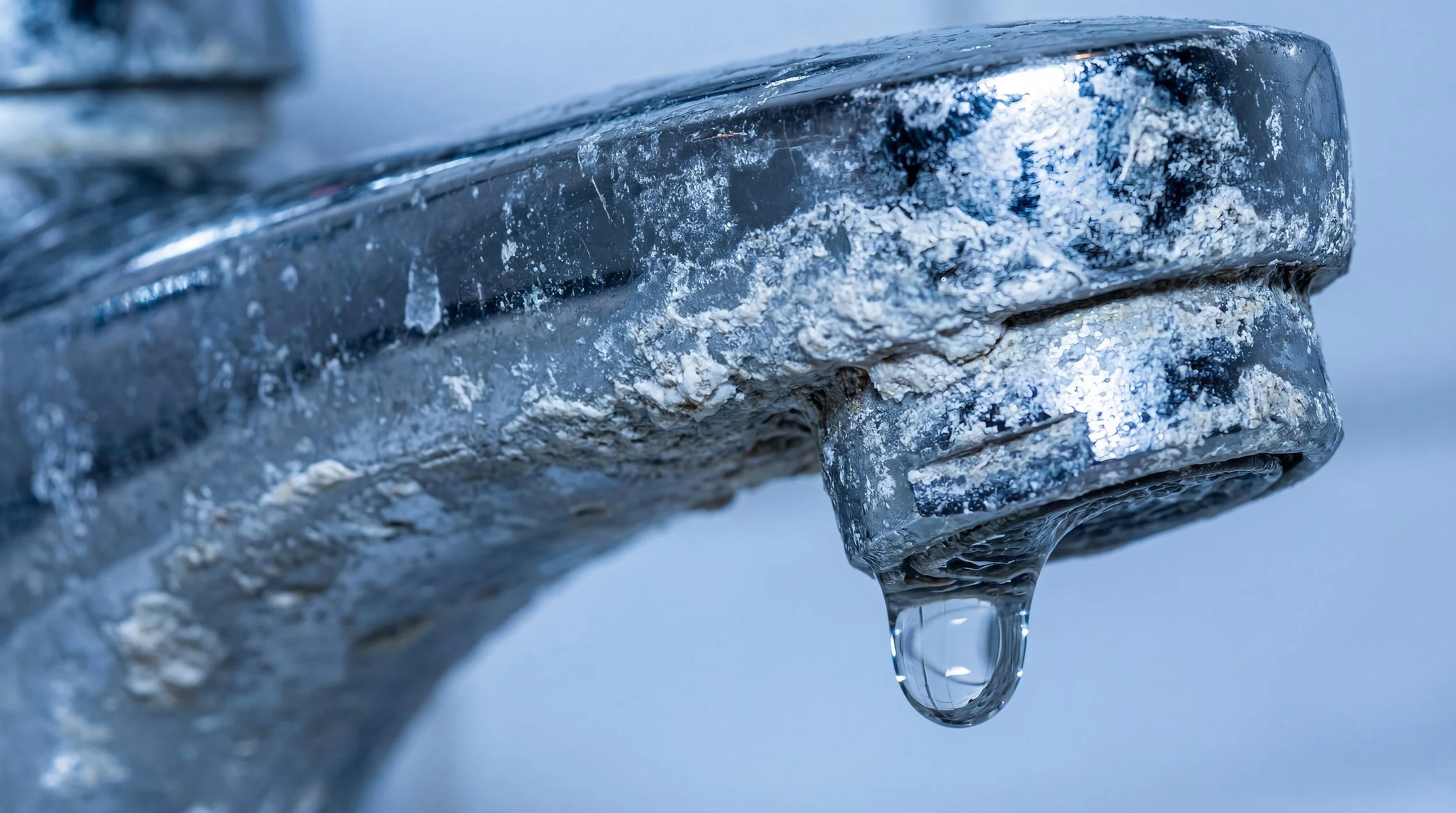 Close-up of a household tap with hard water mineral scale build-up, illustrating the effects of hard water on plumbing fixtures in Perth homes.