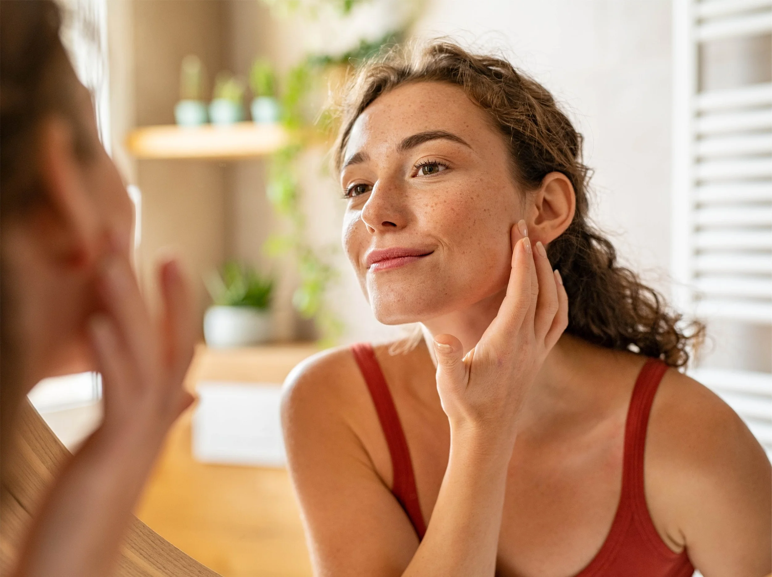 Woman enjoying healthier-looking skin thanks to whole-home water filtration by ClearHaven in Perth.