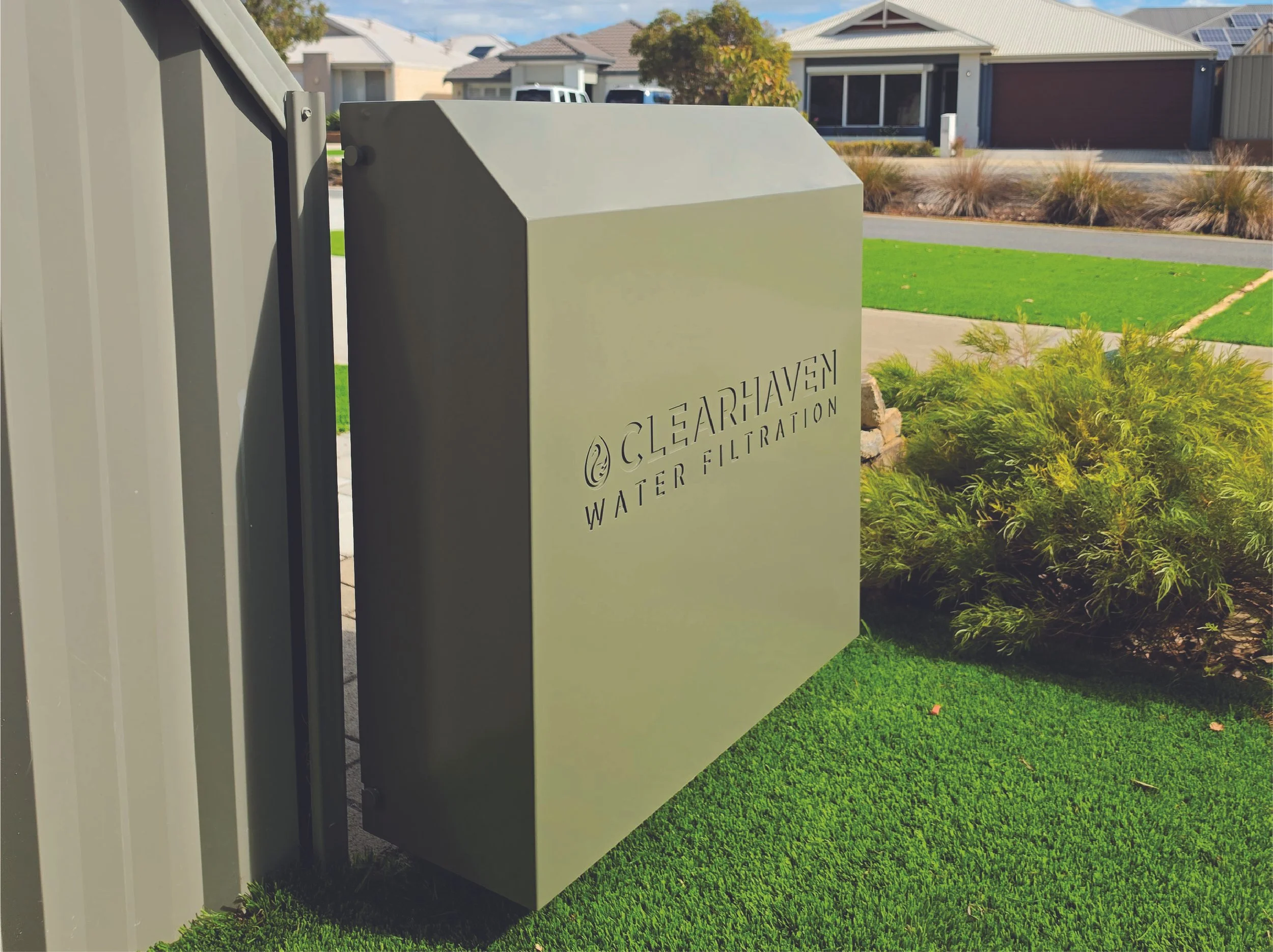 Premium ClearHaven whole-home water filtration installation in Wandi featuring a custom Mangrove powder-coated cover, professionally integrated beside the home with clean architectural styling and landscaped surrounds.