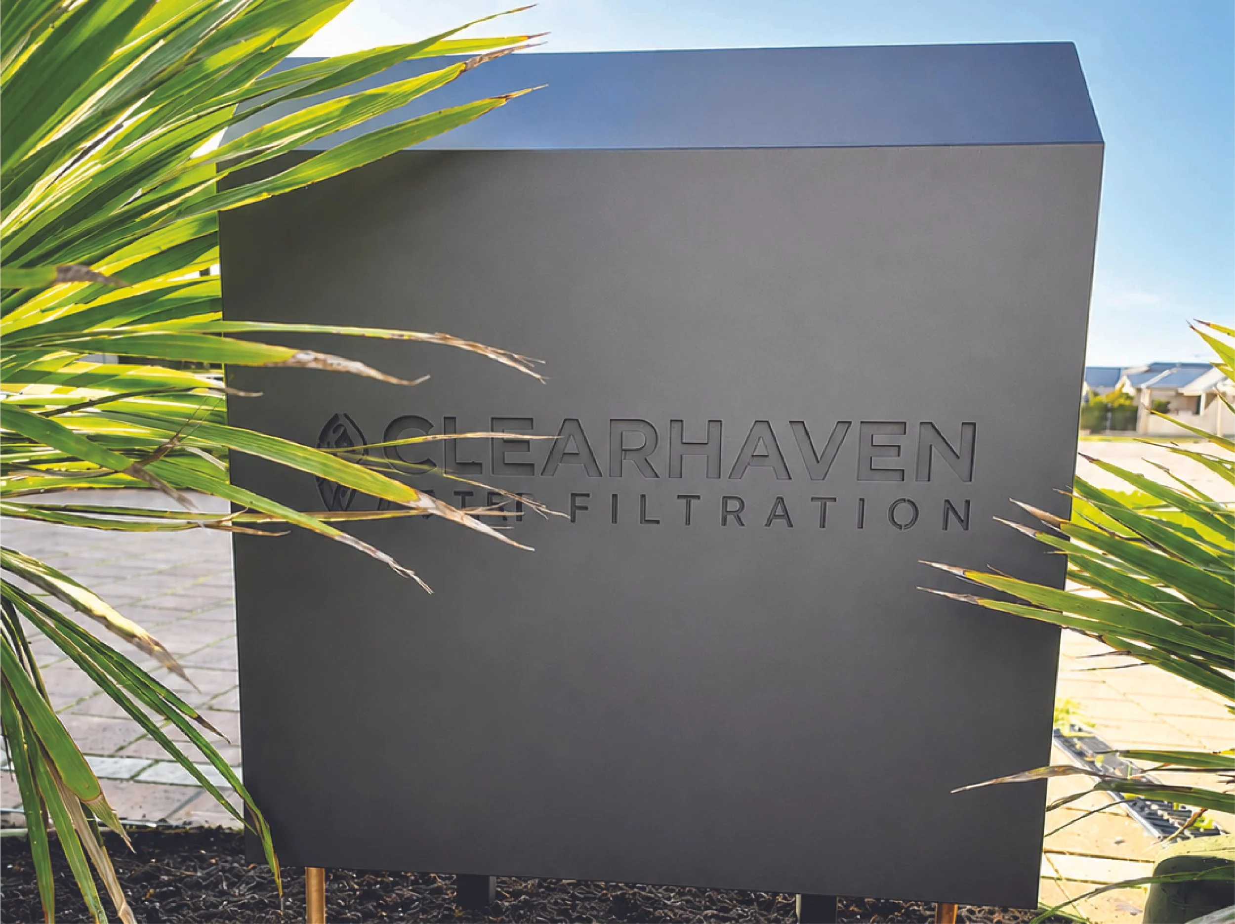 ClearHaven whole-home water filtration installation in Success, Perth, featuring a custom Monument powder-coated aluminium cover with discreet copper pipework and a premium architecturally integrated design.