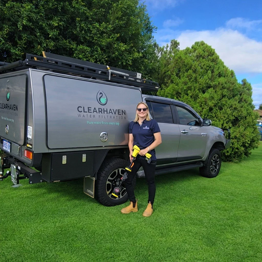 Jade De Joode, founder of ClearHaven Water Filtration, standing beside the ClearHaven service vehicle in Perth.