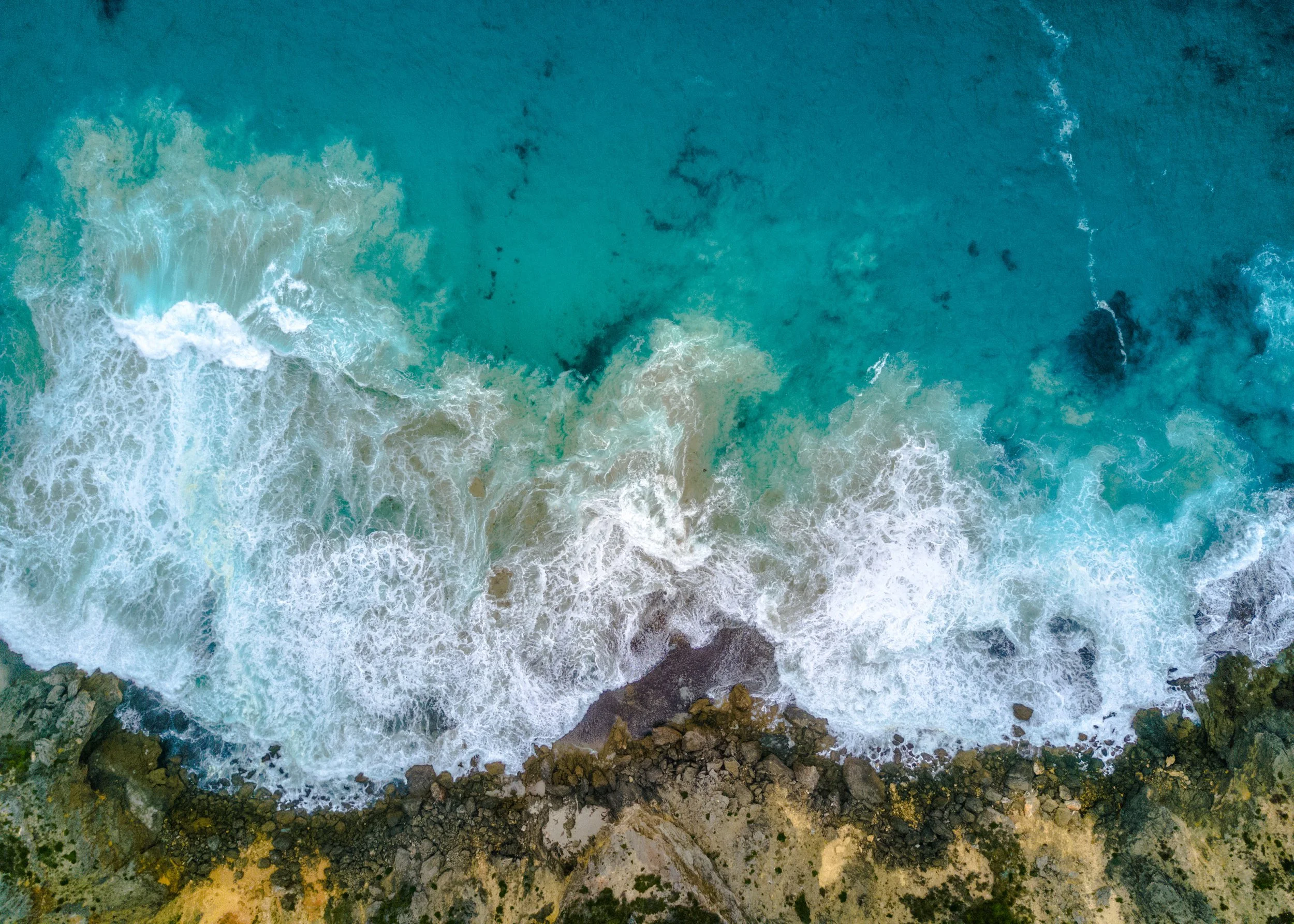 Aerial view of Perth's limestone coastline, illustrating the natural geology and groundwater sources that contribute to hard water and dissolved calcium and magnesium minerals.