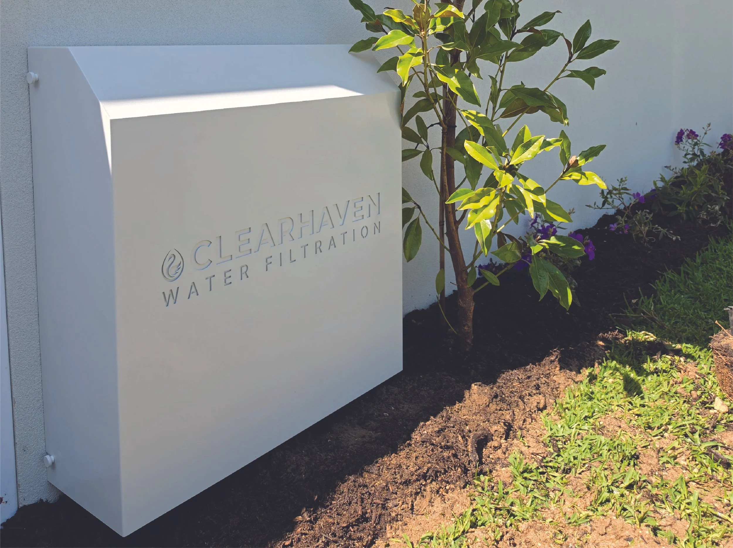 ClearHaven whole-home water filtration system with a Surfmist cover, beautifully integrated beside the home in Burns Beach, WA.