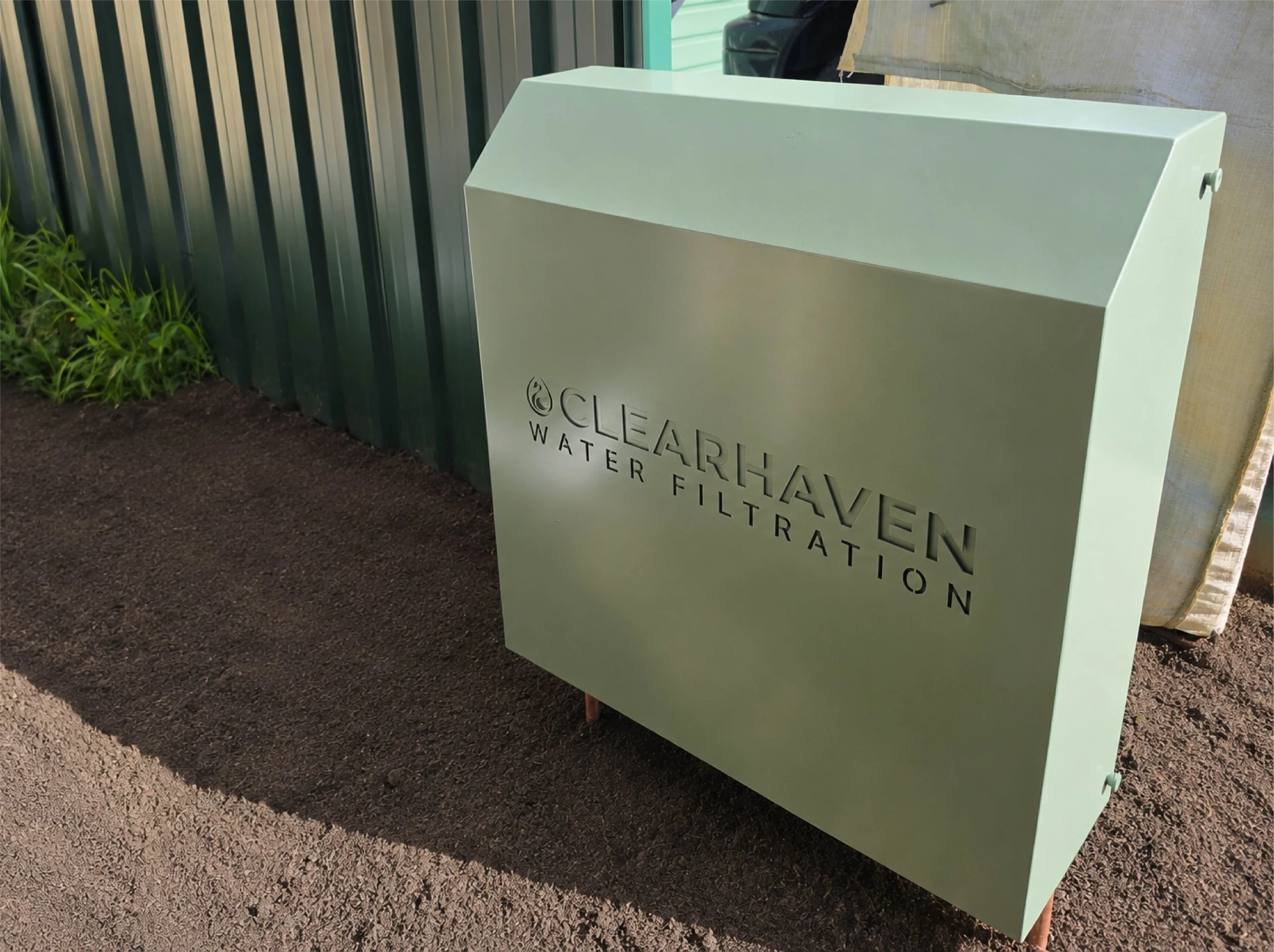 ClearHaven whole-home water filtration system with a custom Pale Eucalypt Colourbond cover professionally installed at a Perth home.