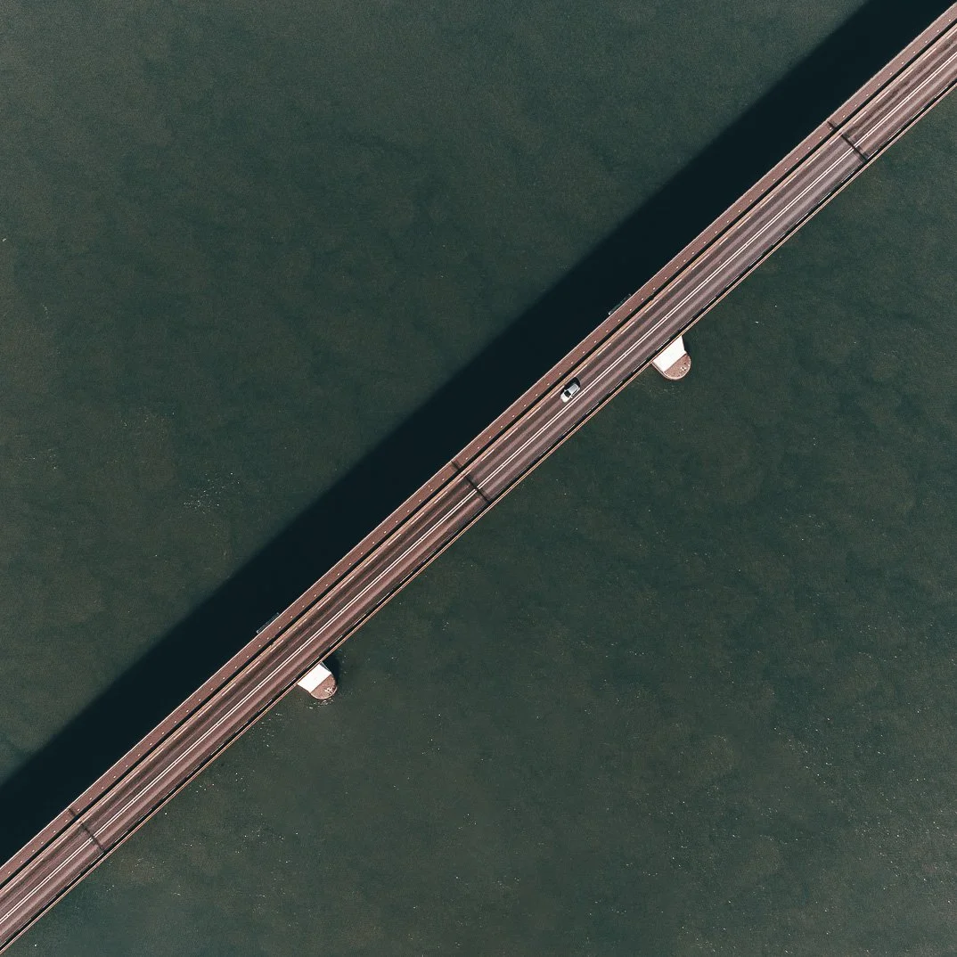 An aerial view of a bridge over a body of water.