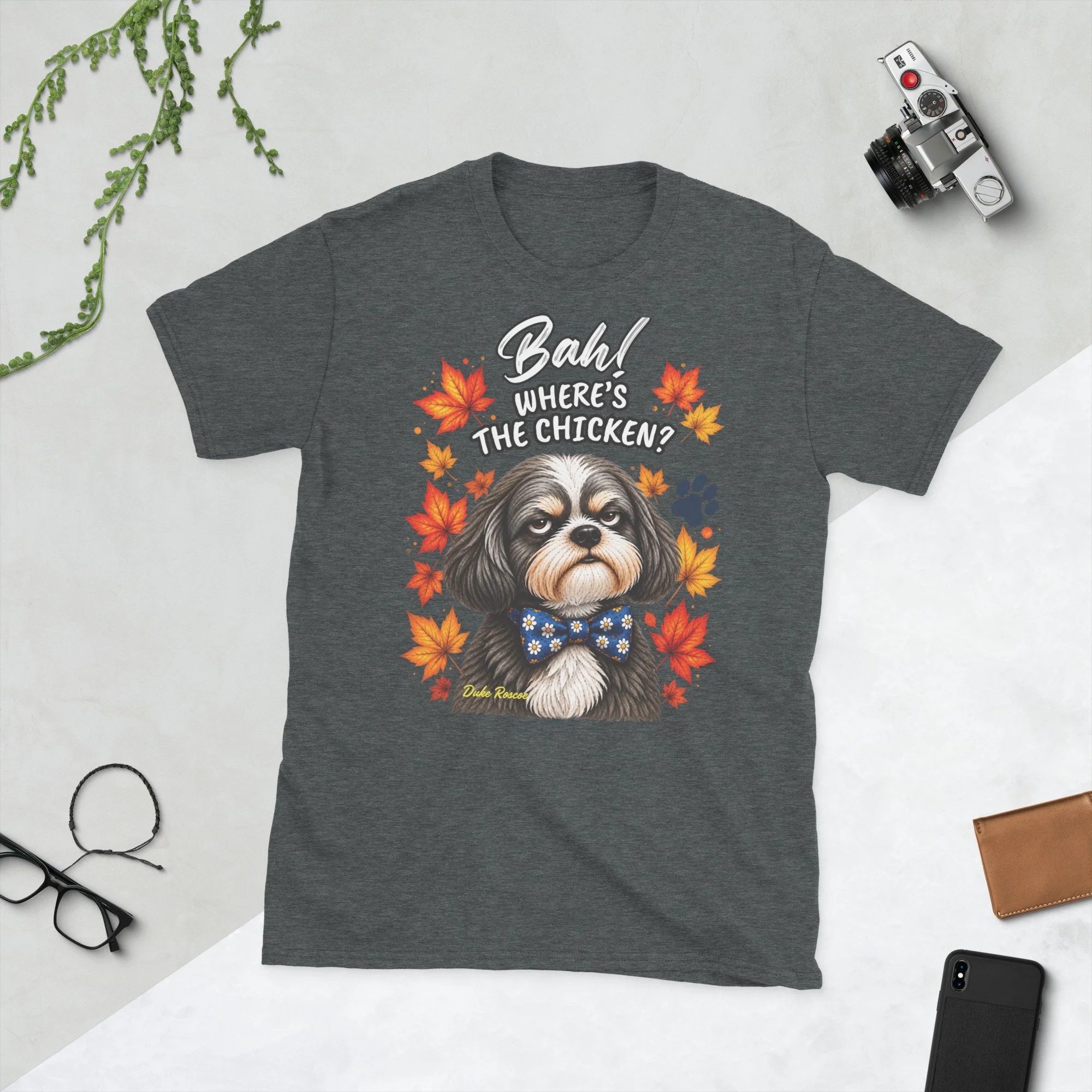 Bah! Where's the Chicken? Duke Roscoe Tee in dark heather, flat lay: grumpy Shih Tzu in a blue bow tie amid autumn leaves