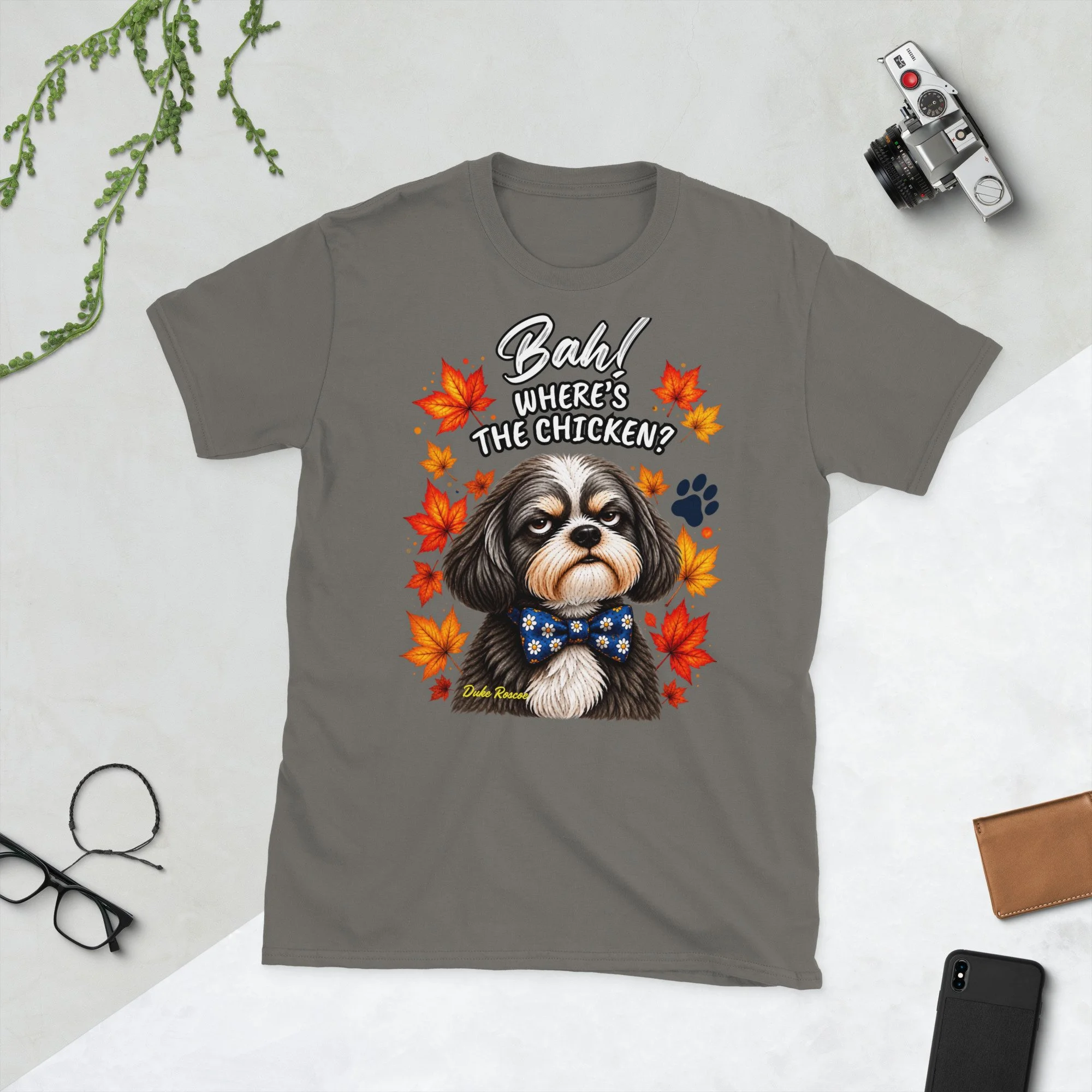 Bah! Where's the Chicken? Duke Roscoe Tee in charcoal, flat lay: grumpy Shih Tzu in a blue bow tie amid autumn leaves