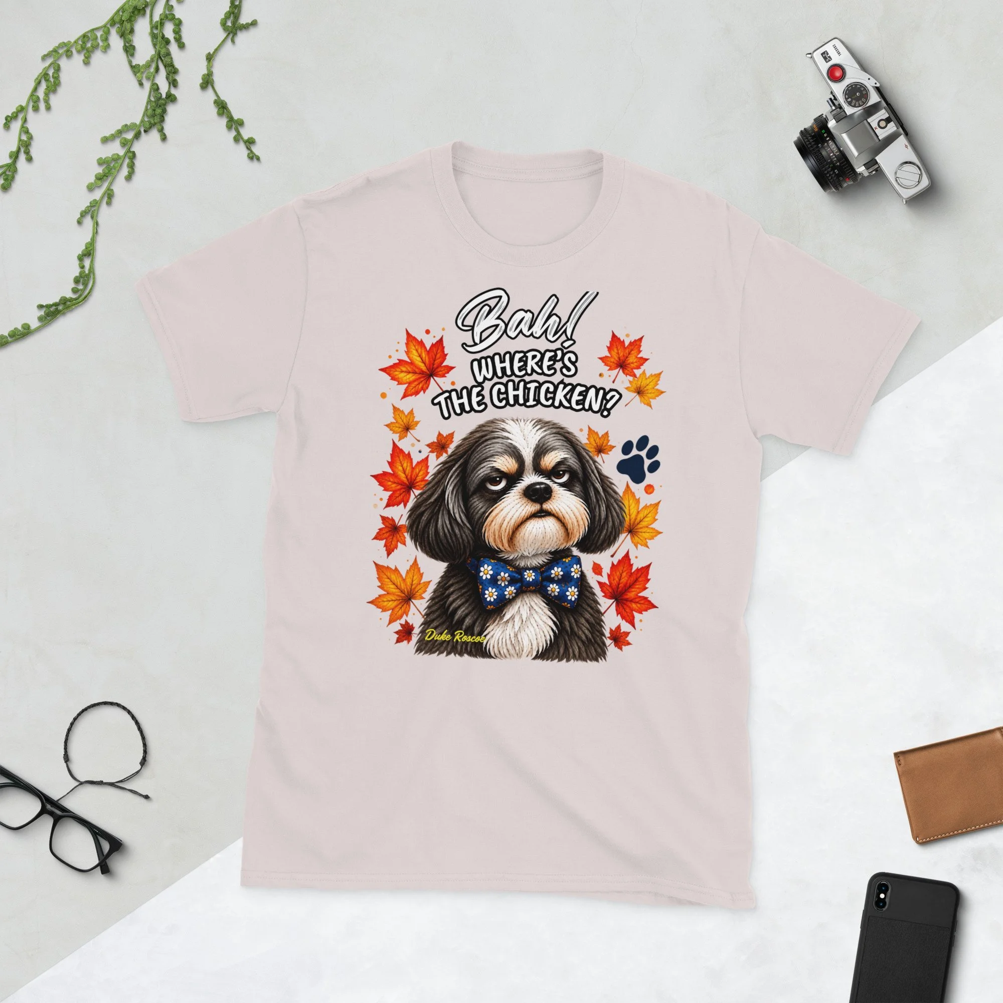 Bah! Where's the Chicken? Duke Roscoe Tee in ice grey, flat lay: grumpy Shih Tzu in a blue bow tie amid autumn leaves